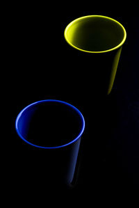 Close-up of empty coffee cups against black background