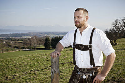 Man standing on field against sky