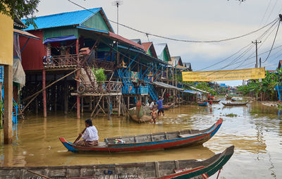 People in boat against sky