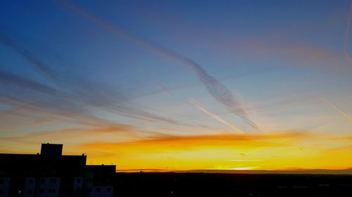 Low angle view of silhouette buildings against sky during sunset