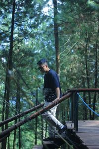 Rear view of man standing in forest