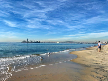 People on beach against sky