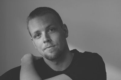 Portrait of young man against gray background