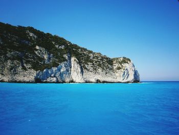 Scenic view of sea against clear blue sky