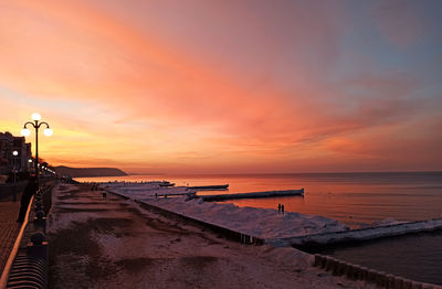 Scenic view of beach against sky during sunset