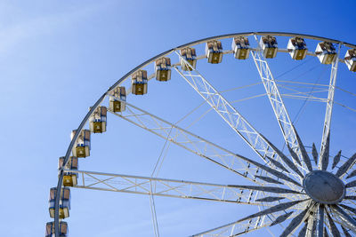 Low angle view of ferris wheel against sky