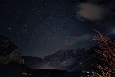 Low angle view of mountain against star field