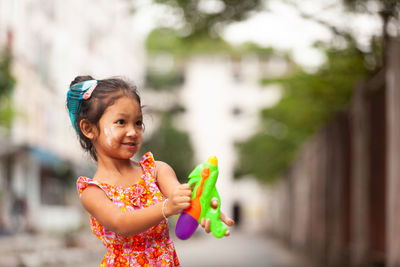 Portrait of smiling girl holding outdoors