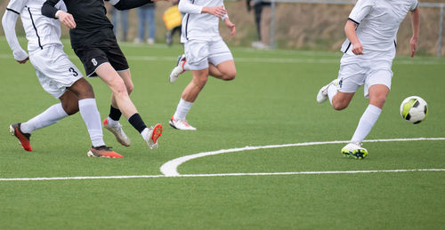 People playing soccer on field