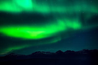 Scenic view of mountains against sky at night