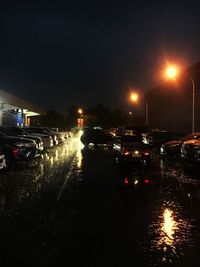 Illuminated city street during rainy season at night