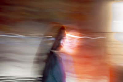 Digital composite image of woman and light trails