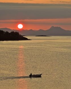 Scenic view of sea against orange sky