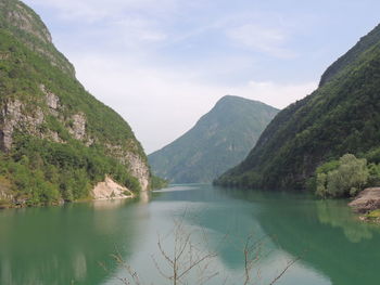 Scenic view of lake and mountains against sky