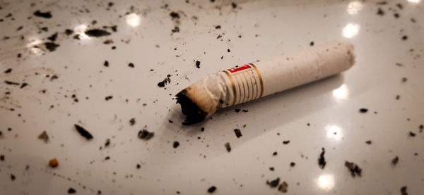 High angle view of cigarette smoking on table