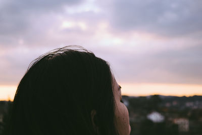 Cropped image of woman head against sky