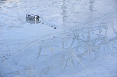 High angle view of broken radio on frozen street during winter