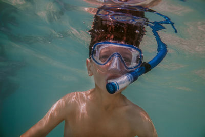 Portrait of shirtless boy snorkeling in sea