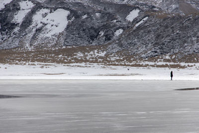 Scenic view of sea and mountains during winter