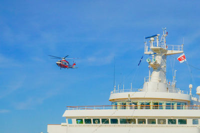 Low angle view of ship against clear blue sky