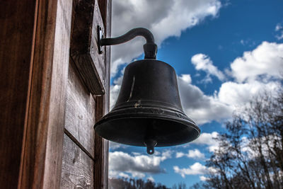 Low angle view of electric lamp against sky