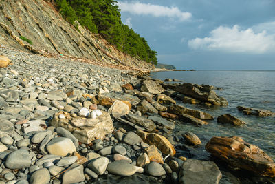 Rocks on beach against sky