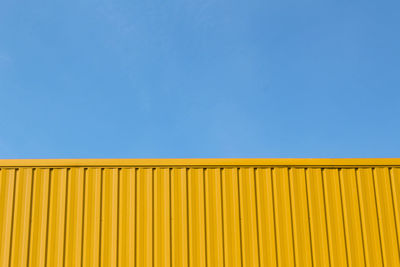 Low angle view of yellow against clear blue sky