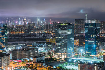 High angle view of illuminated buildings in city at night