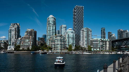 View of modern buildings in city against sky