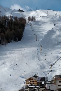 High angle view of ski lift over snow covered mountain