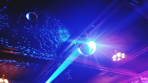 Low angle view of illuminated lights at night