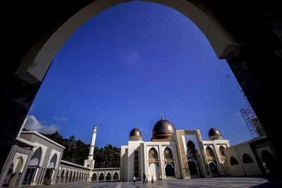 Low angle view of historical building against blue sky