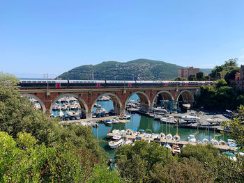 Arch bridge over river against sky