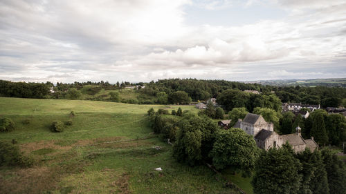 Scenic view of grassy field against cloudy sky