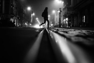 Man walking on illuminated city at night