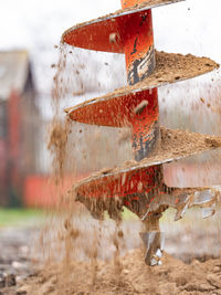 Close-up of red metallic structure on land