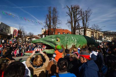 Crowd in traditional city against sky