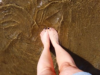 Low section of woman legs on beach