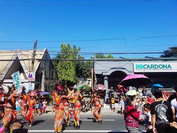 People on street against blue sky