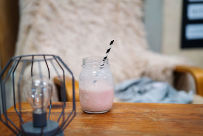 Pink smoothie on the wooden cozy table