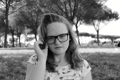 Portrait of girl wearing sunglasses on field