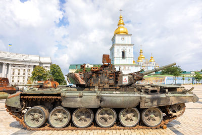 A rusty russian tank at an exhibition of destroyed russian military equipment .