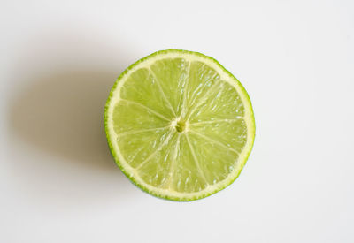 Close-up of lemon slice against white background