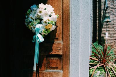 Close-up of flower wreath on door