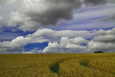 Scenic view of dramatic landscape against cloudy sky