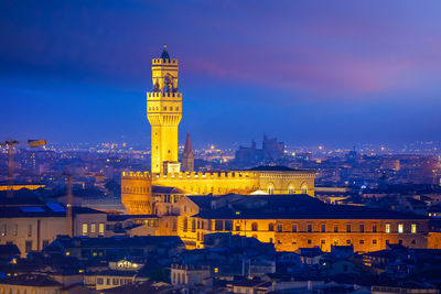 High angle view of illuminated buildings in city at night