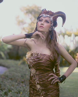 Portrait of smiling young woman standing on field
