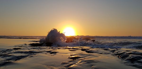 Scenic view of sea against sky during sunset