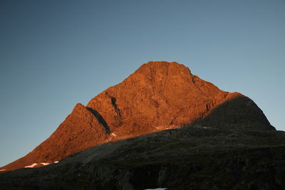 Low angle view of rock formations against sky