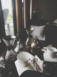 Coffee cup on table against window